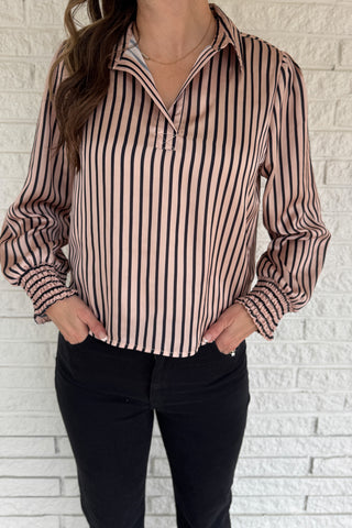 Soft satin with a polished drape, this striped top feels elevated yet easy. The relaxed silhouette and split neckline make it simple to style, while the vertical stripes elongate your frame. Smocked cuffs add a feminine finishing touch. Dress it up for work or keep it casual with denim.