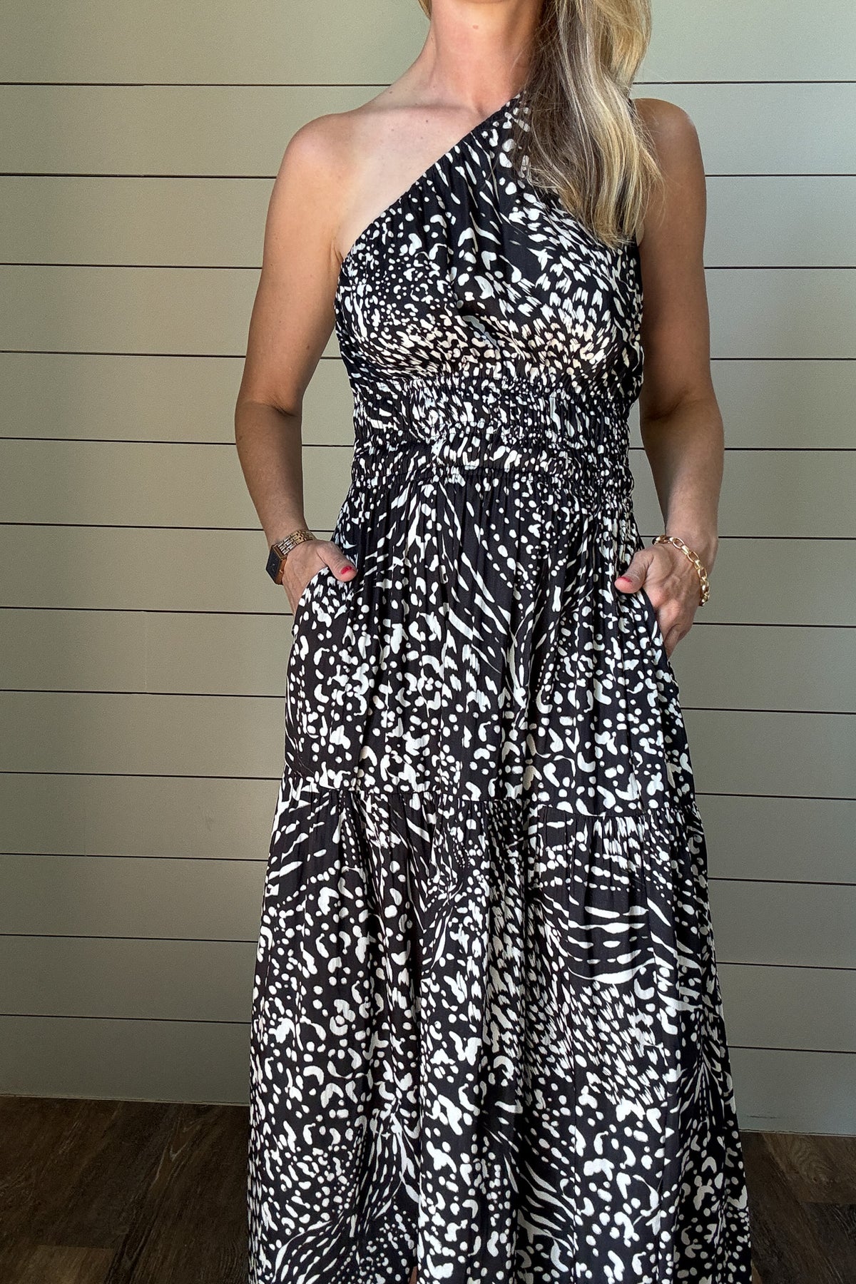 &nbsp;Make a statement with this sleek and modern one-shoulder dress. The satin fabric gives it just the right amount of sheen, while the black and white abstract print adds a bold twist. It’s unlined and lightweight—perfect for summer nights or dressing up your everyday. The smocked waist keeps things flattering, and yes—it has pockets. Wear it with slides or a strappy heel and you're good to go.&nbsp;Make a statement with this sleek and modern one-shoulder dress. The satin fabric gives it just the right a