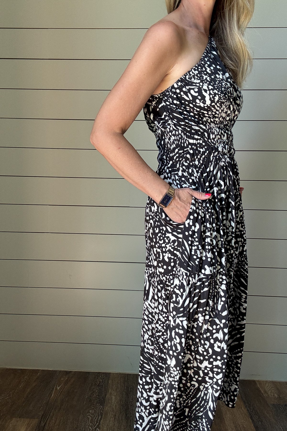 &nbsp;Make a statement with this sleek and modern one-shoulder dress. The satin fabric gives it just the right amount of sheen, while the black and white abstract print adds a bold twist. It’s unlined and lightweight—perfect for summer nights or dressing up your everyday. The smocked waist keeps things flattering, and yes—it has pockets. Wear it with slides or a strappy heel and you're good to go.