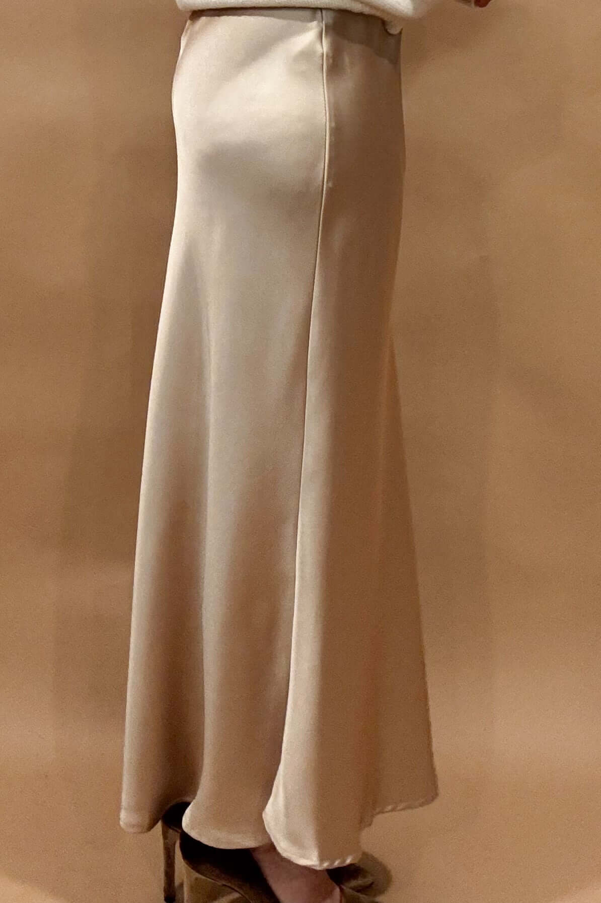 Indulge in luxury and elegance with our Champagne Satin Maxi Skirt. The elastic waist band ensures a comfortable and flattering fit, while the thick fabric holds its shape for a stunning silhouette. The champagne toned satin adds a touch of sophistication to any outfit.