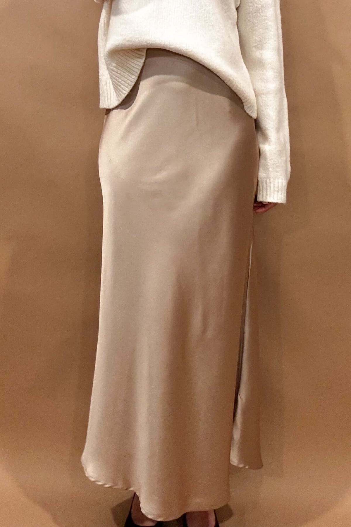 Indulge in luxury and elegance with our Champagne Satin Maxi Skirt. The elastic waist band ensures a comfortable and flattering fit, while the thick fabric holds its shape for a stunning silhouette. The champagne toned satin adds a touch of sophistication to any outfit.