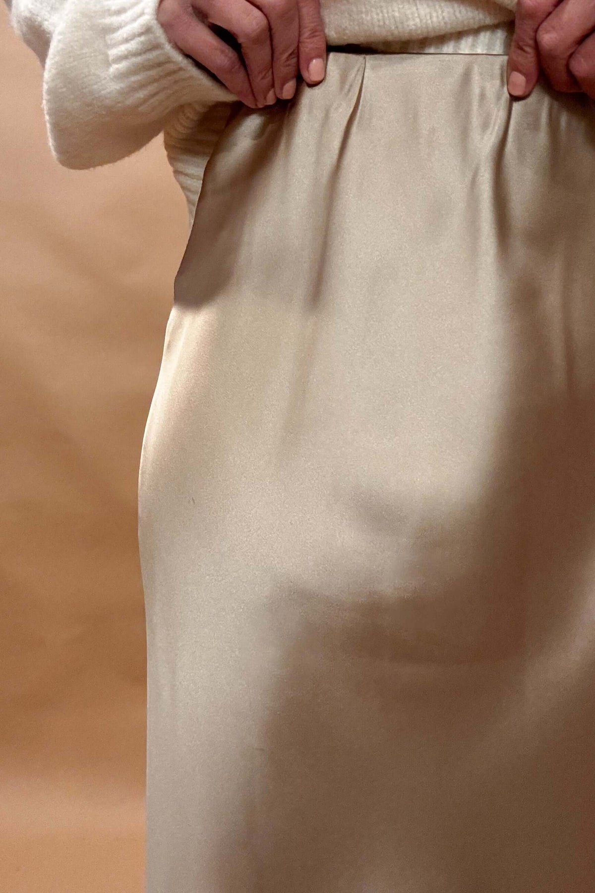 Indulge in luxury and elegance with our Champagne Satin Maxi Skirt. The elastic waist band ensures a comfortable and flattering fit, while the thick fabric holds its shape for a stunning silhouette. The champagne toned satin adds a touch of sophistication to any outfit.