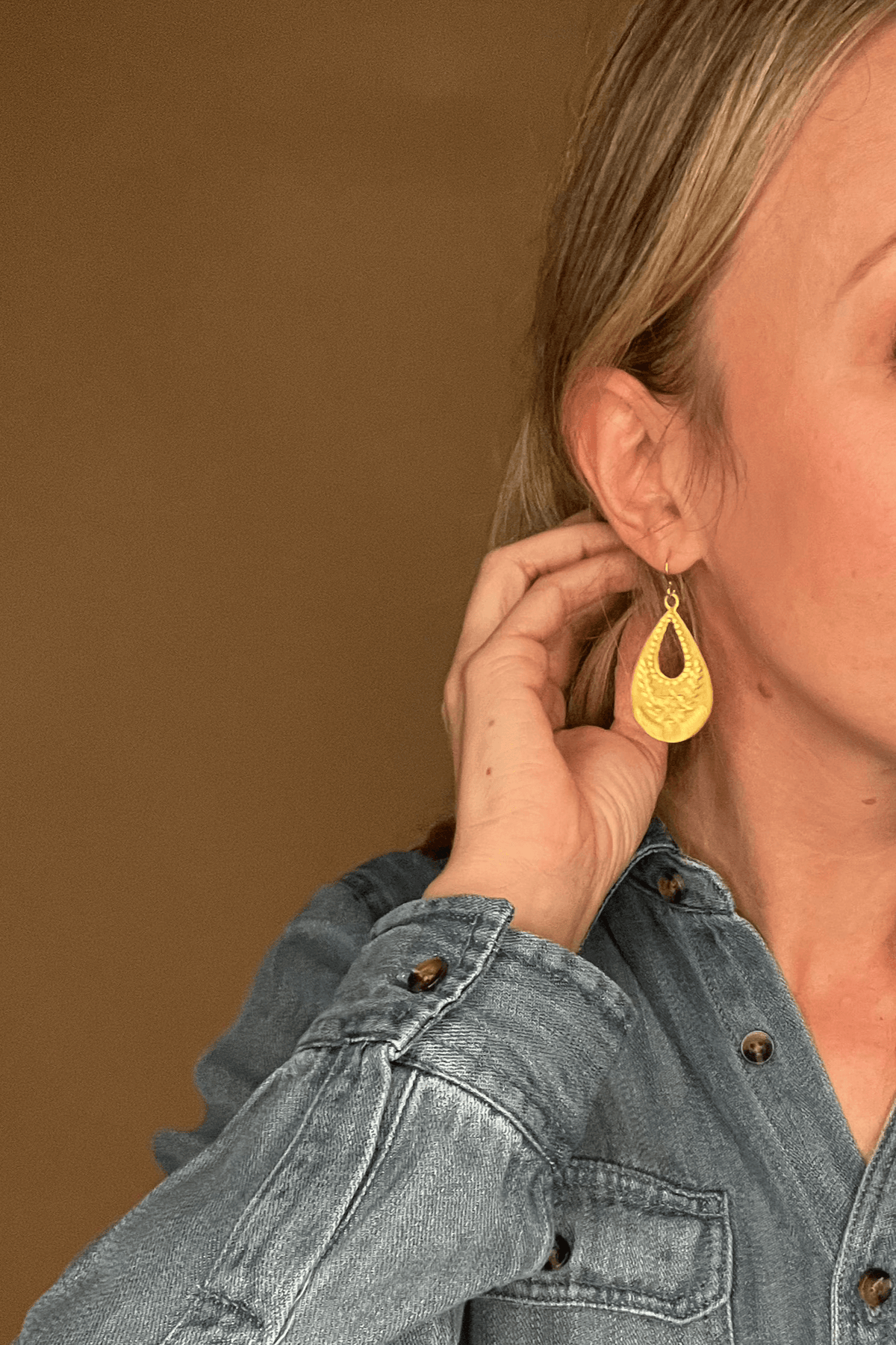 <p><span>Matte gold vintaged styled flower stamped teardrop hoop earrings on 10k gold plated ear wires. They hang approximately 2 1/8 inches. </span></p> <p>Hand made in the USA</p>