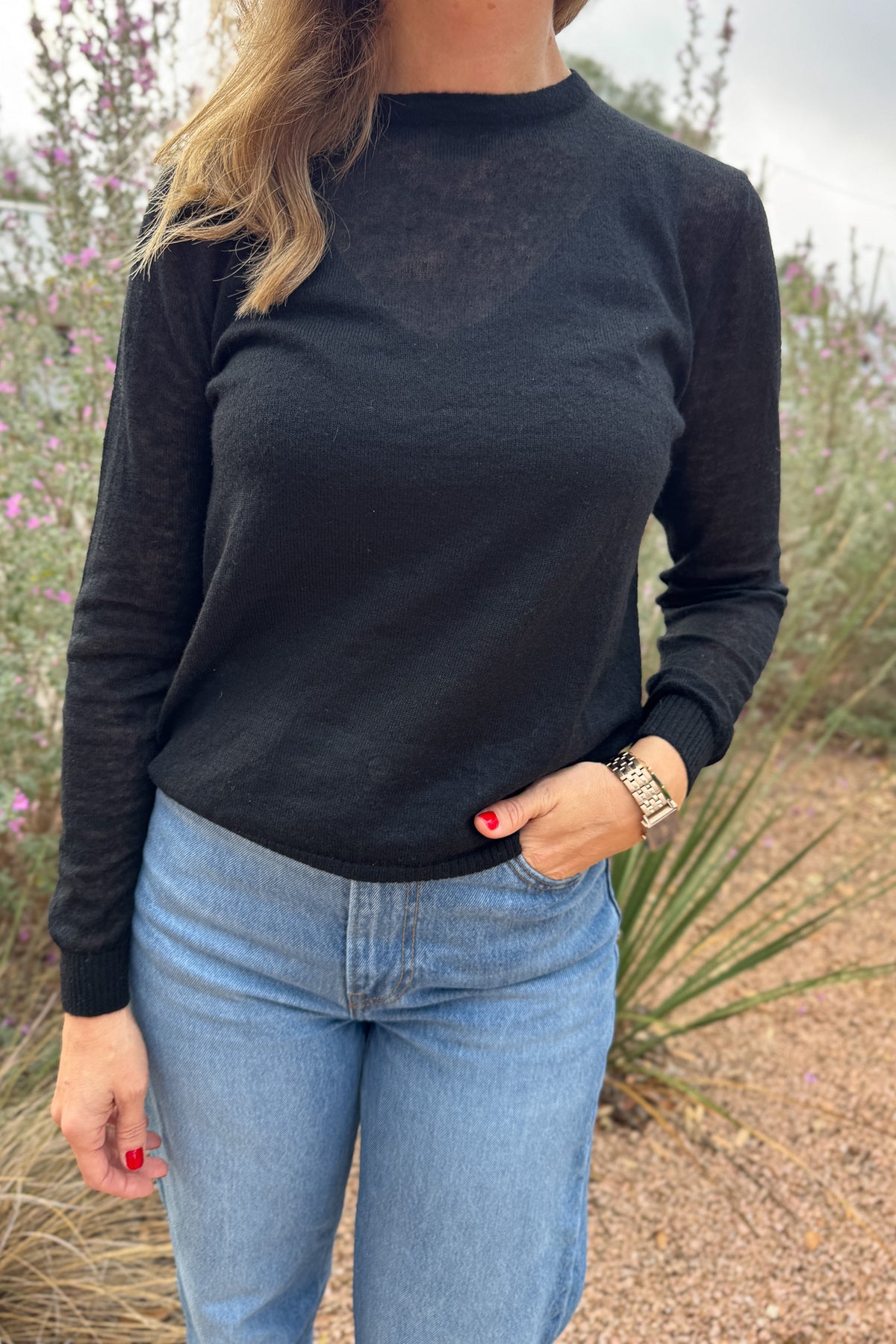 An elevated basic with an unexpected twist. This lightweight knit features a classic crew front and a modern crossover open-back detail. Soft with a hint of warmth, it’s perfect for layering over a tank or cami. Effortless with denim yet chic enough for a night out.