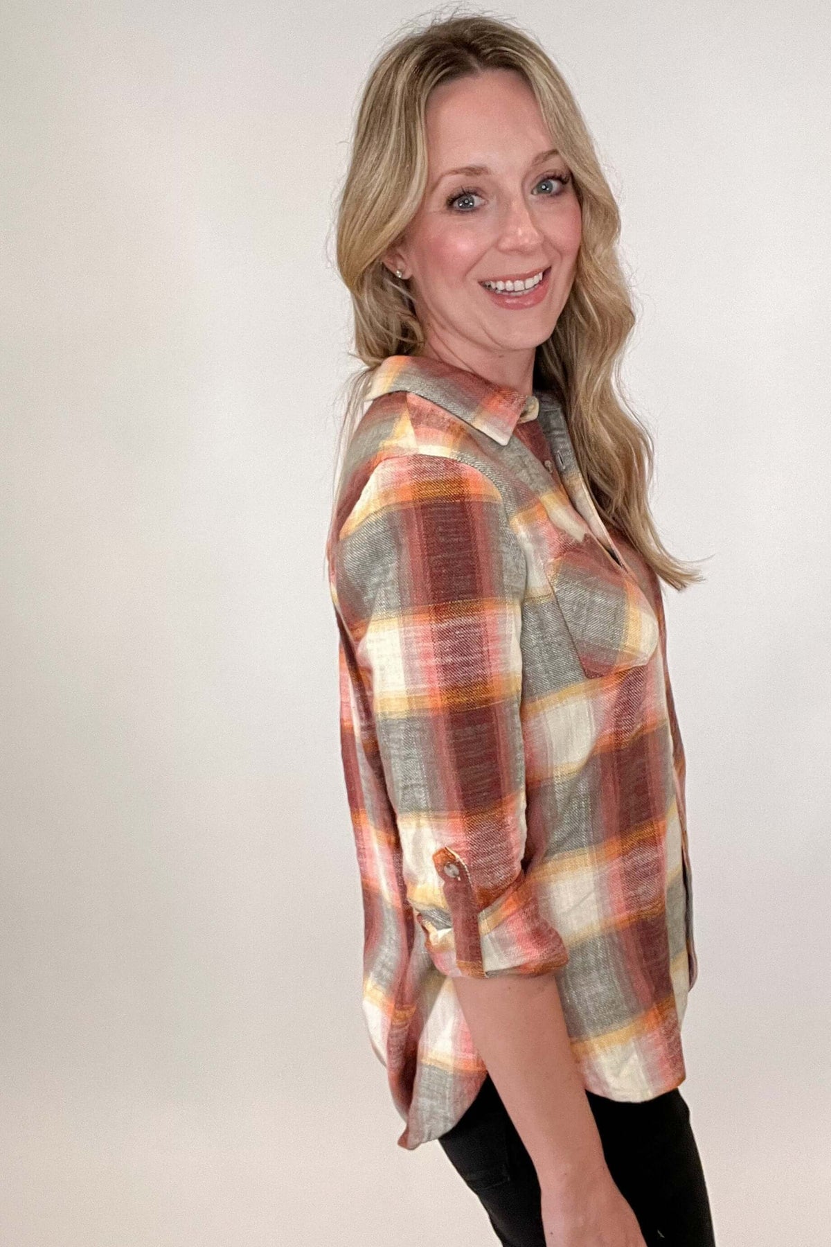 Power through autumn in chic style with our Sunset Plaid Blouse. The effortless plaid shirt will be your go-to look on cool days, featuring shades of sunset on a collared button up design. Elegantly enduring yet infinitely modern, this plaid blouse takes your wardrobe to the next level.