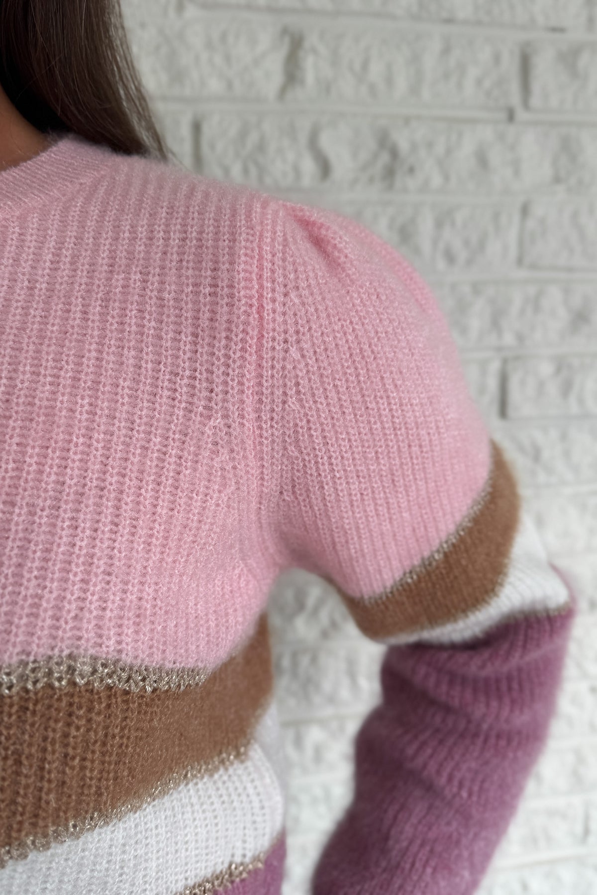 Soft and playful, this zigzag striped sweater adds a cheerful pop of color to your fall lineup. Designed with subtle shoulder gathers and a touch of shimmer in the thread, it blends comfort with a hint of fun. The mix of pink, ivory, and taupe tones makes it an easy piece to dress up or keep casual.