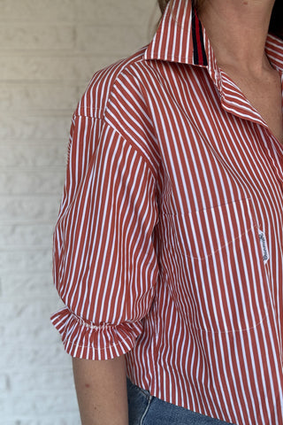 An upcycled men’s shirt reworked into a (mom) crop, raw hem, easy silhouette that feels fresh and relaxed. The orange striped cotton keeps it classic while the slightly billowed sleeves add a fun twist. Soft, breathable, and one-of-a-kind. Designed to be a one size fits most, wear it buttoned up and it fits like an XS or small, wear it open and it fits size medium or large. Women's fashion boutique Blanco Texas Johnson City Texas