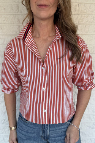 An upcycled men’s shirt reworked into a (mom) crop, raw hem, easy silhouette that feels fresh and relaxed. The orange striped cotton keeps it classic while the slightly billowed sleeves add a fun twist. Soft, breathable, and one-of-a-kind. Designed to be a one size fits most, wear it buttoned up and it fits like an XS or small, wear it open and it fits size medium or large. Women's fashion boutique Blanco Texas Johnson City Texas
