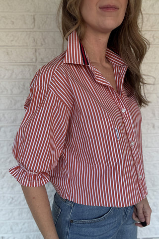 An upcycled men’s shirt reworked into a (mom) crop, raw hem, easy silhouette that feels fresh and relaxed. The orange striped cotton keeps it classic while the slightly billowed sleeves add a fun twist. Soft, breathable, and one-of-a-kind. Designed to be a one size fits most, wear it buttoned up and it fits like an XS or small, wear it open and it fits size medium or large. Women's fashion boutique Blanco Texas Johnson City Texas
