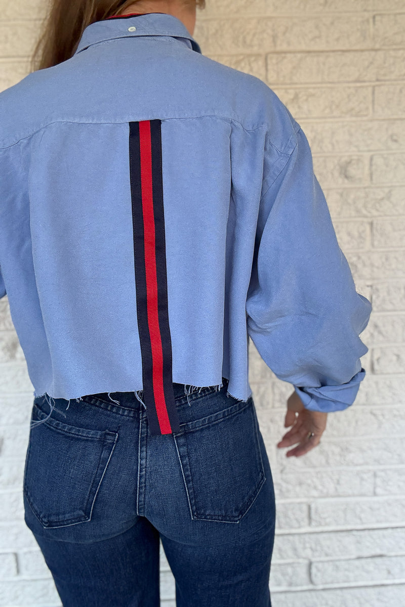 An upcycled men’s shirt reworked into a cropped, raw hem, easy silhouette that feels fresh and relaxed. Large front pockets add a fun twist to the buttery soft shirt. Soft, breathable, and one-of-a-kind. Designed to be a one size fits most, wear it buttoned up and it fits like an XS or small, wear it open and it fits size medium or large. Women's fashion boutique Blanco Texas