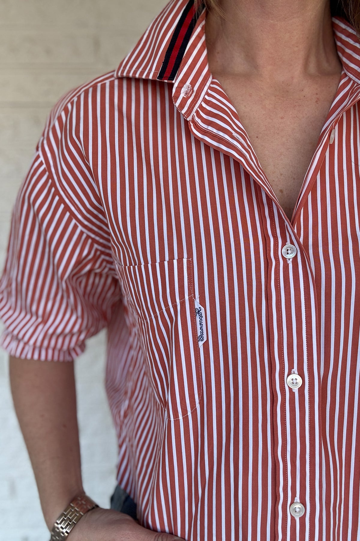 An upcycled men’s shirt reworked into a (mom) crop, raw hem, easy silhouette that feels fresh and relaxed. The orange striped cotton keeps it classic while the slightly billowed sleeves add a fun twist. Soft, breathable, and one-of-a-kind. Designed to be a one size fits most, wear it buttoned up and it fits like an XS or small, wear it open and it fits size medium or large.