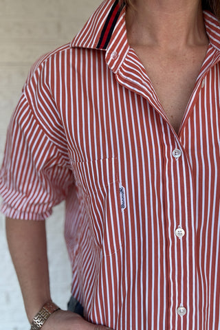 An upcycled men’s shirt reworked into a (mom) crop, raw hem, easy silhouette that feels fresh and relaxed. The orange striped cotton keeps it classic while the slightly billowed sleeves add a fun twist. Soft, breathable, and one-of-a-kind. Designed to be a one size fits most, wear it buttoned up and it fits like an XS or small, wear it open and it fits size medium or large. Women's fashion boutique Blanco Texas Johnson City Texas