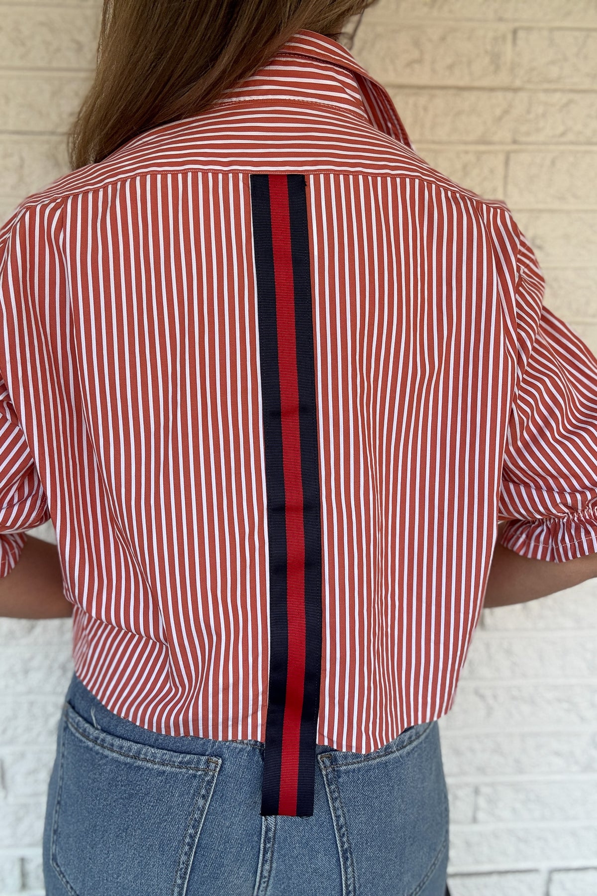 An upcycled men’s shirt reworked into a (mom) crop, raw hem, easy silhouette that feels fresh and relaxed. The orange striped cotton keeps it classic while the slightly billowed sleeves add a fun twist. Soft, breathable, and one-of-a-kind. Designed to be a one size fits most, wear it buttoned up and it fits like an XS or small, wear it open and it fits size medium or large.