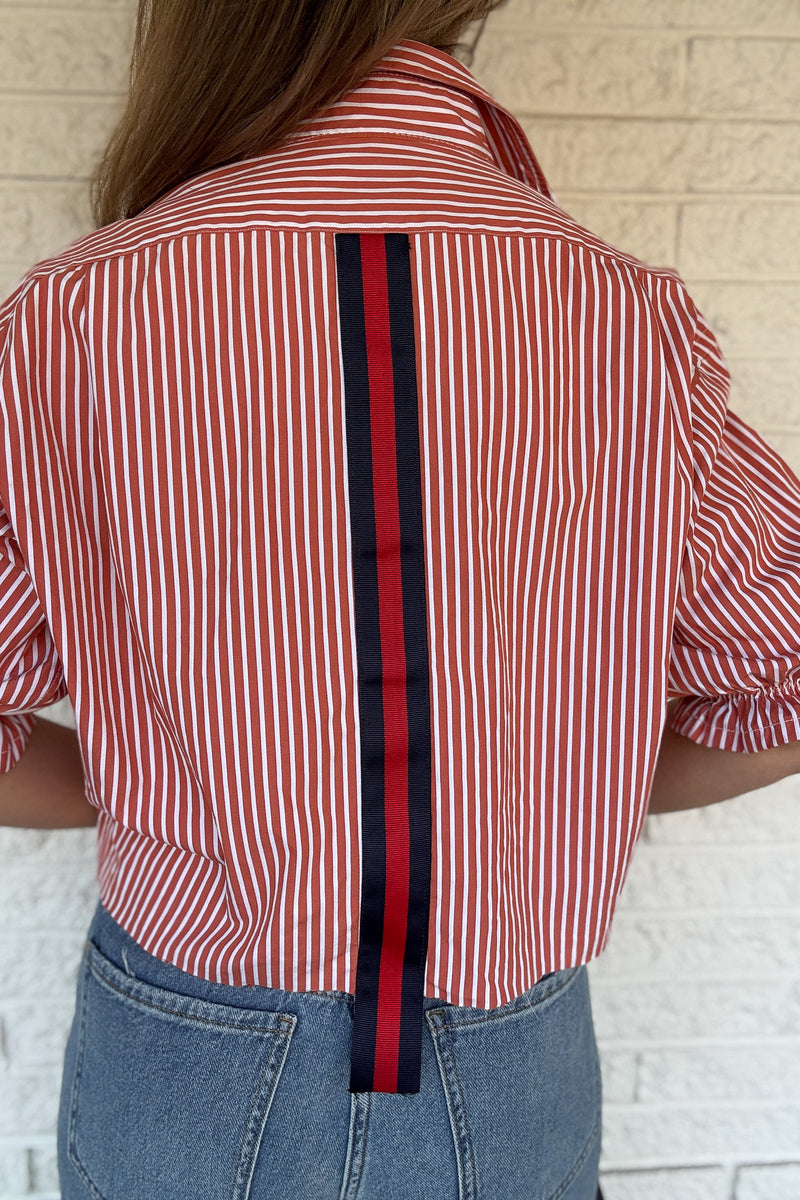 An upcycled men’s shirt reworked into a (mom) crop, raw hem, easy silhouette that feels fresh and relaxed. The orange striped cotton keeps it classic while the slightly billowed sleeves add a fun twist. Soft, breathable, and one-of-a-kind. Designed to be a one size fits most, wear it buttoned up and it fits like an XS or small, wear it open and it fits size medium or large. Women's fashion boutique Blanco Texas Johnson City Texas