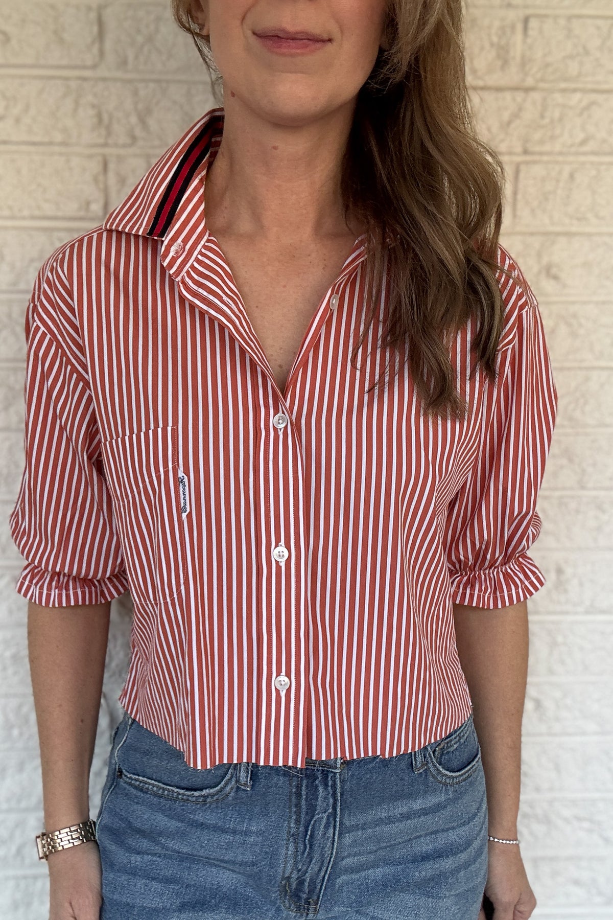 An upcycled men’s shirt reworked into a (mom) crop, raw hem, easy silhouette that feels fresh and relaxed. The orange striped cotton keeps it classic while the slightly billowed sleeves add a fun twist. Soft, breathable, and one-of-a-kind. Designed to be a one size fits most, wear it buttoned up and it fits like an XS or small, wear it open and it fits size medium or large.