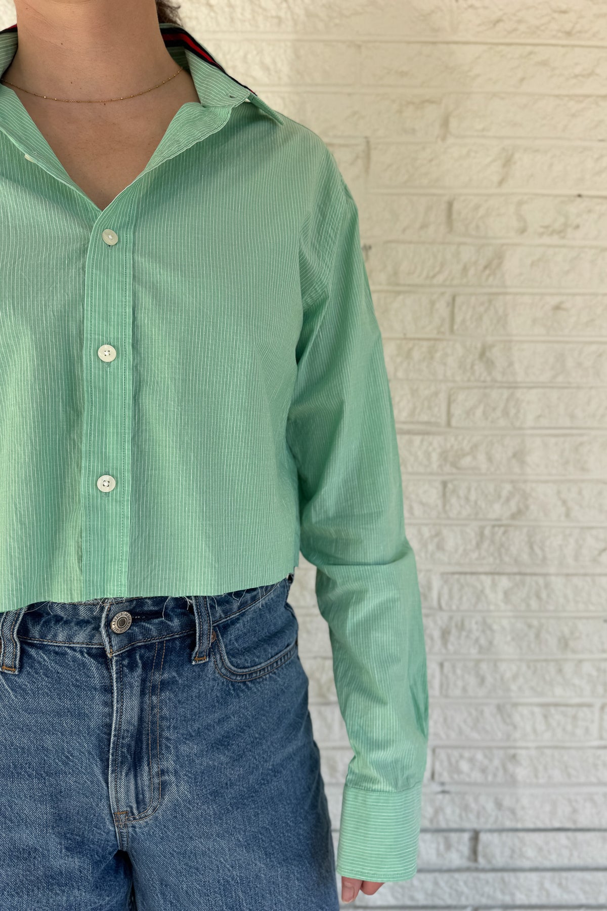 An upcycled men’s shirt reworked into a cropped, raw hem, easy silhouette that feels fresh and relaxed. Soft, feminine, and one-of-a-kind. Designed to be a one size fits most when worn open, wear it buttoned up and it fits like small or medium.
