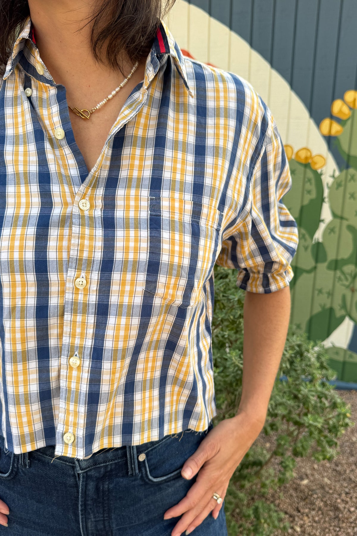 Made in USA VonVie Stella top with vintage plaid, button-front styling, ruffle cuffs, and contrasting back ribbon detail.