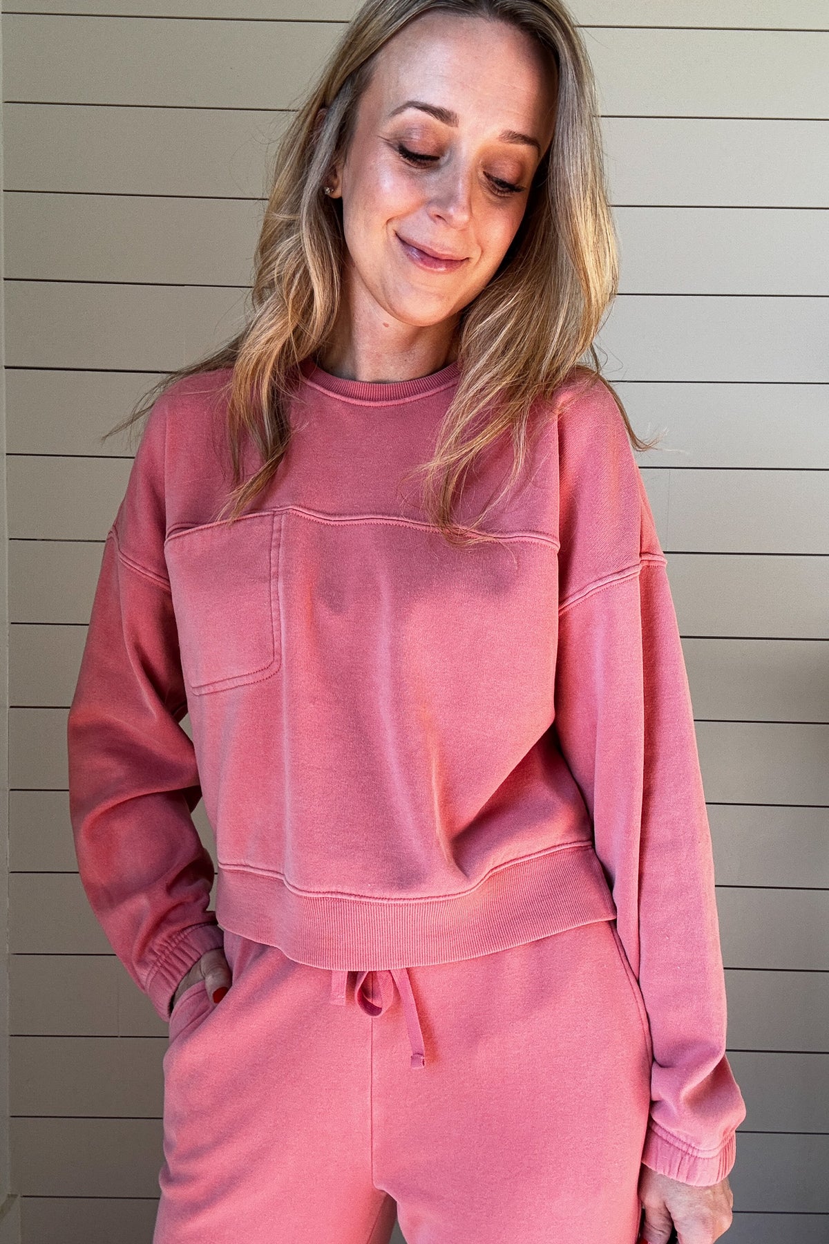 Stay cozy and stylish with our Strawberry Cream Sweatshirt. The soft, strawberry pink fabric and front chest pocket provide both comfort and practicality, while the seam detailing and small slit on the sides add a touch of uniqueness. Made with a cotton blend, this sweatshirt is perfect for everyday wear. Add it to your wardrobe today!