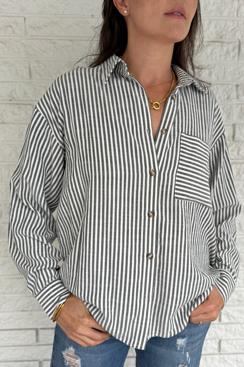 A customer favorite is back! This best-selling striped button-down blend of 51% cotton with 49% polyester for a soft yet crisp feel. The classic vertical stripes and relaxed fit make it perfect for easy, everyday style.