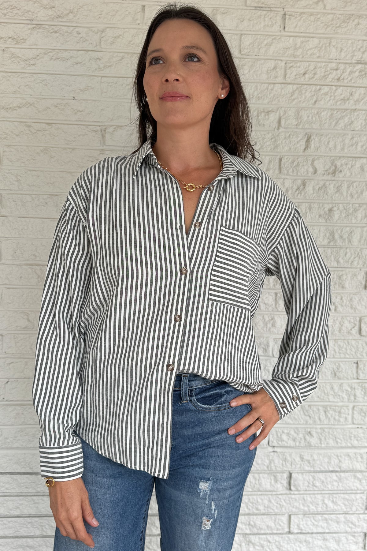 A customer favorite is back! This best-selling striped button-down blend of 51% cotton with 49% polyester for a soft yet crisp feel. The classic vertical stripes and relaxed fit make it perfect for easy, everyday style.