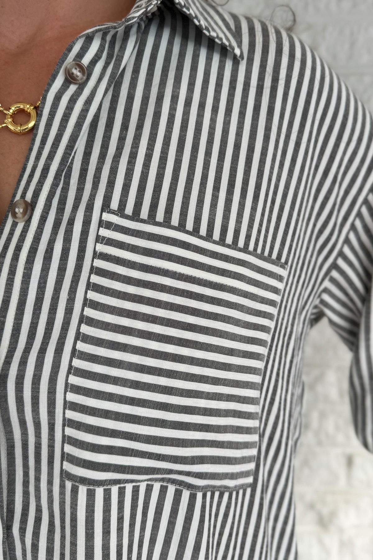 A customer favorite is back! This best-selling striped button-down blend of 51% cotton with 49% polyester for a soft yet crisp feel. The classic vertical stripes and relaxed fit make it perfect for easy, everyday style.
