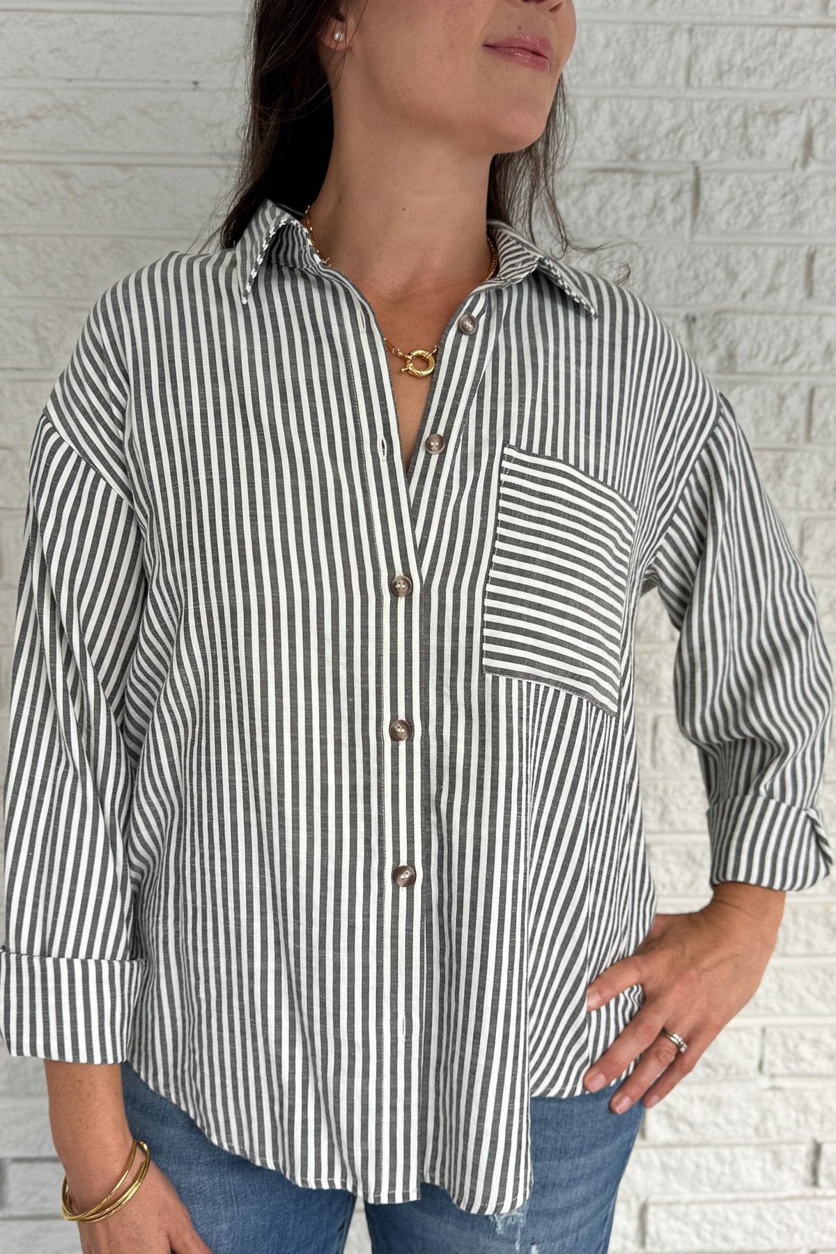 A customer favorite is back! This best-selling striped button-down blend of 51% cotton with 49% polyester for a soft yet crisp feel. The classic vertical stripes and relaxed fit make it perfect for easy, everyday style.
