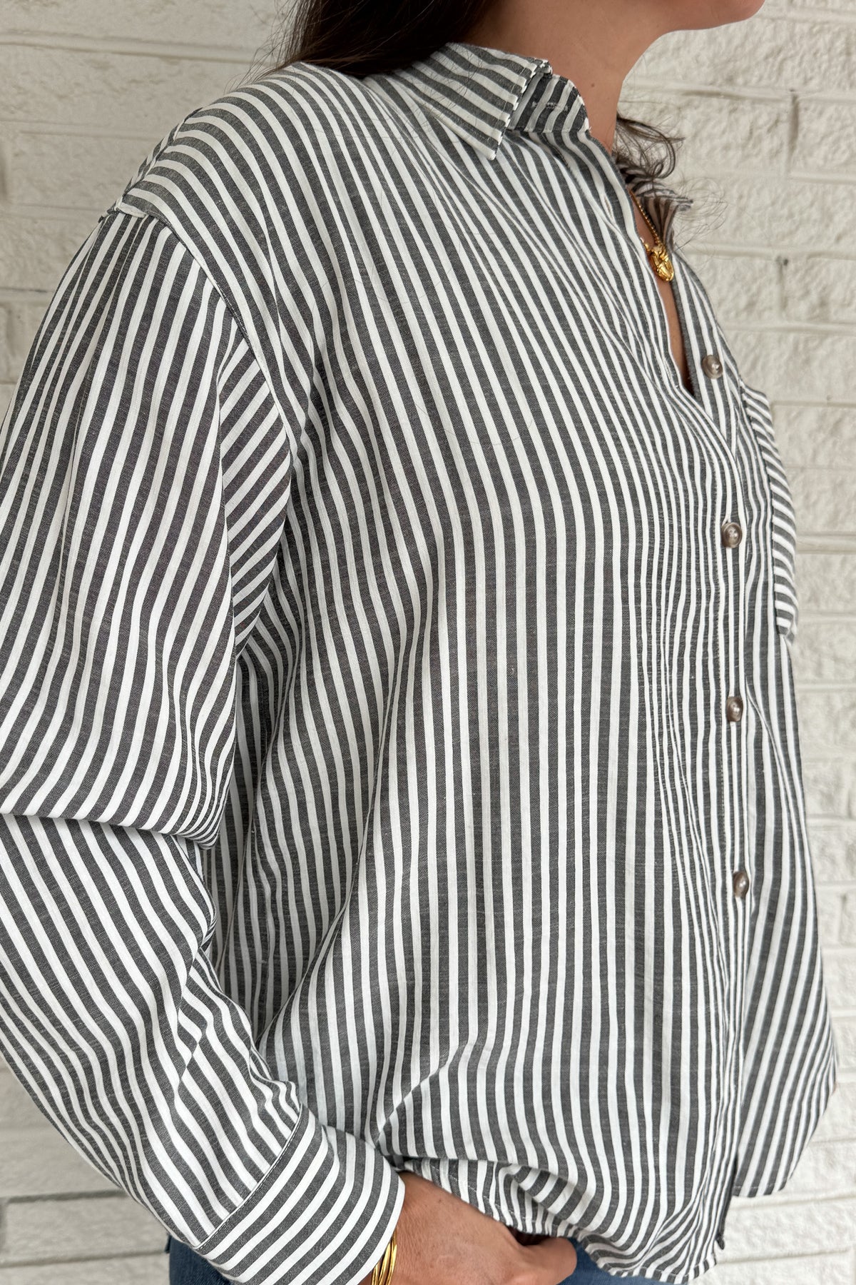 A customer favorite is back! This best-selling striped button-down blend of 51% cotton with 49% polyester for a soft yet crisp feel. The classic vertical stripes and relaxed fit make it perfect for easy, everyday style.
