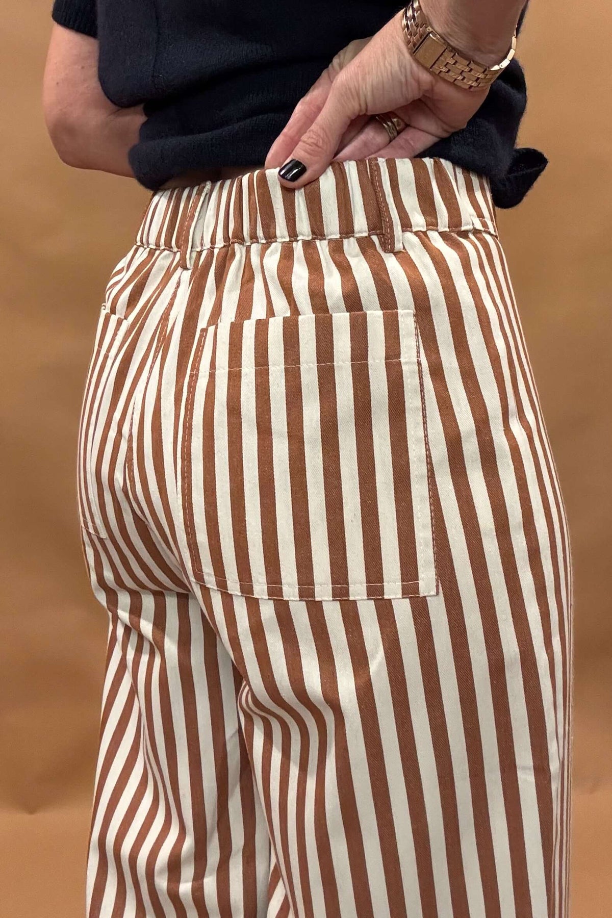 Introducing our Striped Wide Leg Pants, the perfect balance of style and comfort! The vertical stripes create a flattering elongated look, while the elastic back waist and belt loops provide a customizable fit. Button and zip closure with five pockets, these pants offer both functionality and fashion. Lightweight fabric so no bulk with these pants.