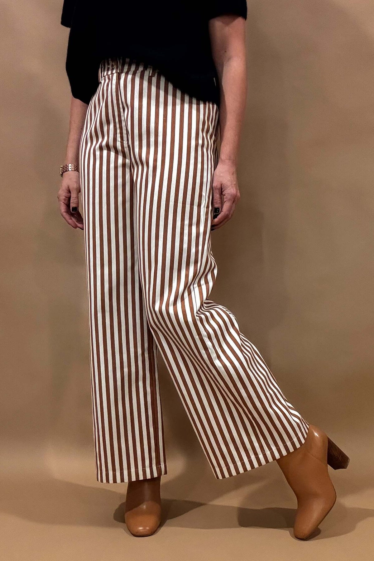 Introducing our Striped Wide Leg Pants, the perfect balance of style and comfort! The vertical stripes create a flattering elongated look, while the elastic back waist and belt loops provide a customizable fit. Button and zip closure with five pockets, these pants offer both functionality and fashion. Lightweight fabric so no bulk with these pants.