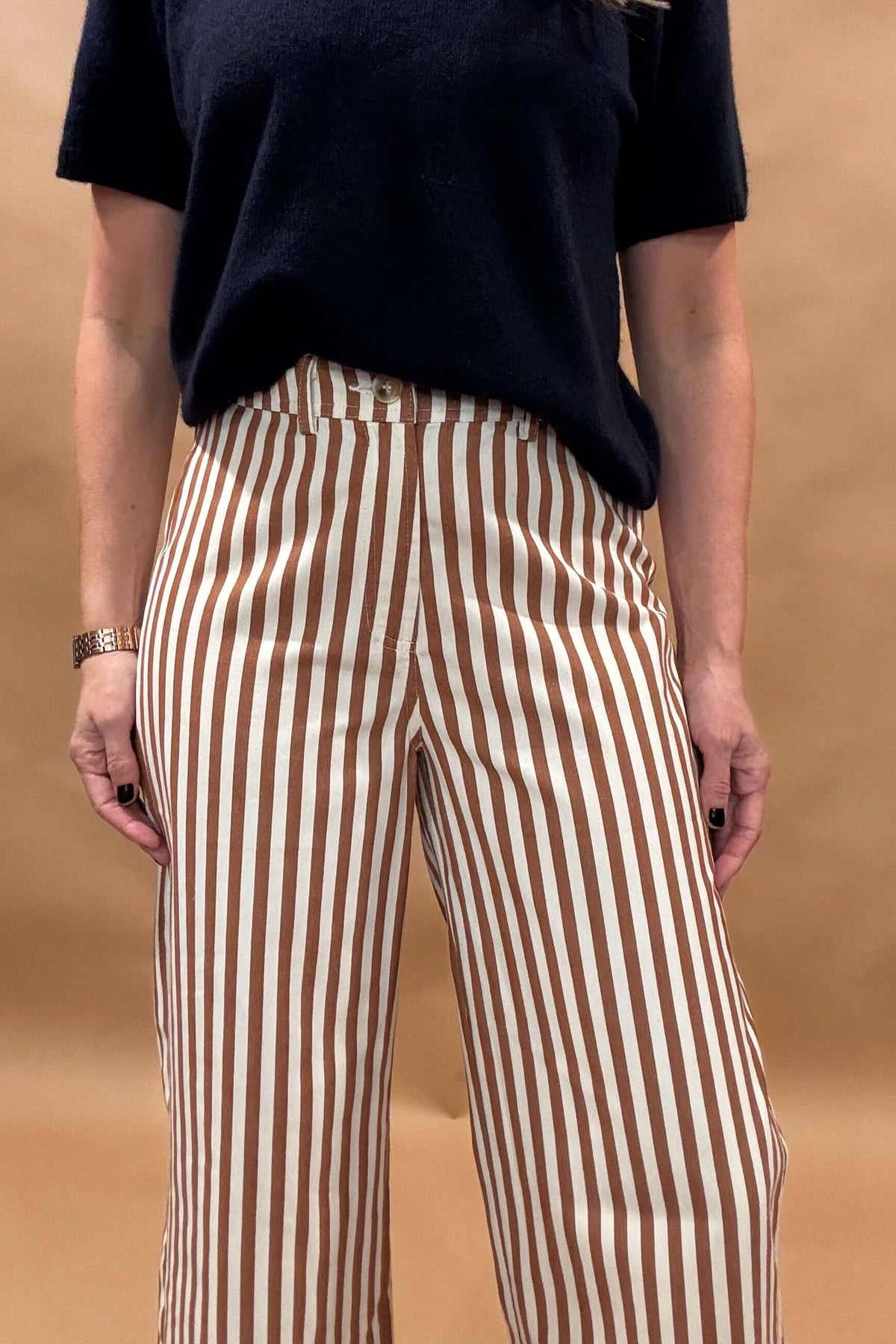 Introducing our Striped Wide Leg Pants, the perfect balance of style and comfort! The vertical stripes create a flattering elongated look, while the elastic back waist and belt loops provide a customizable fit. Button and zip closure with five pockets, these pants offer both functionality and fashion. Lightweight fabric so no bulk with these pants.