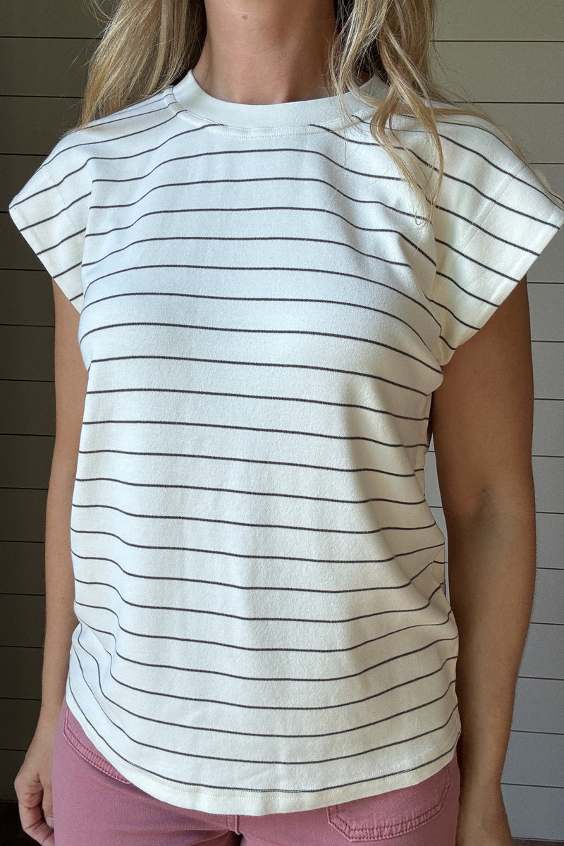 &nbsp;This striped knit top is the definition of easy, everyday style. Made from a soft, medium-weight knit, it drapes beautifully while keeping its shape. The classic ivory base with thin black stripes gives it a timeless look, and the relaxed cap sleeves add just the right amount of detail. Perfect on its own or layered under a jacket, it’s the kind of piece you’ll reach for all year long.