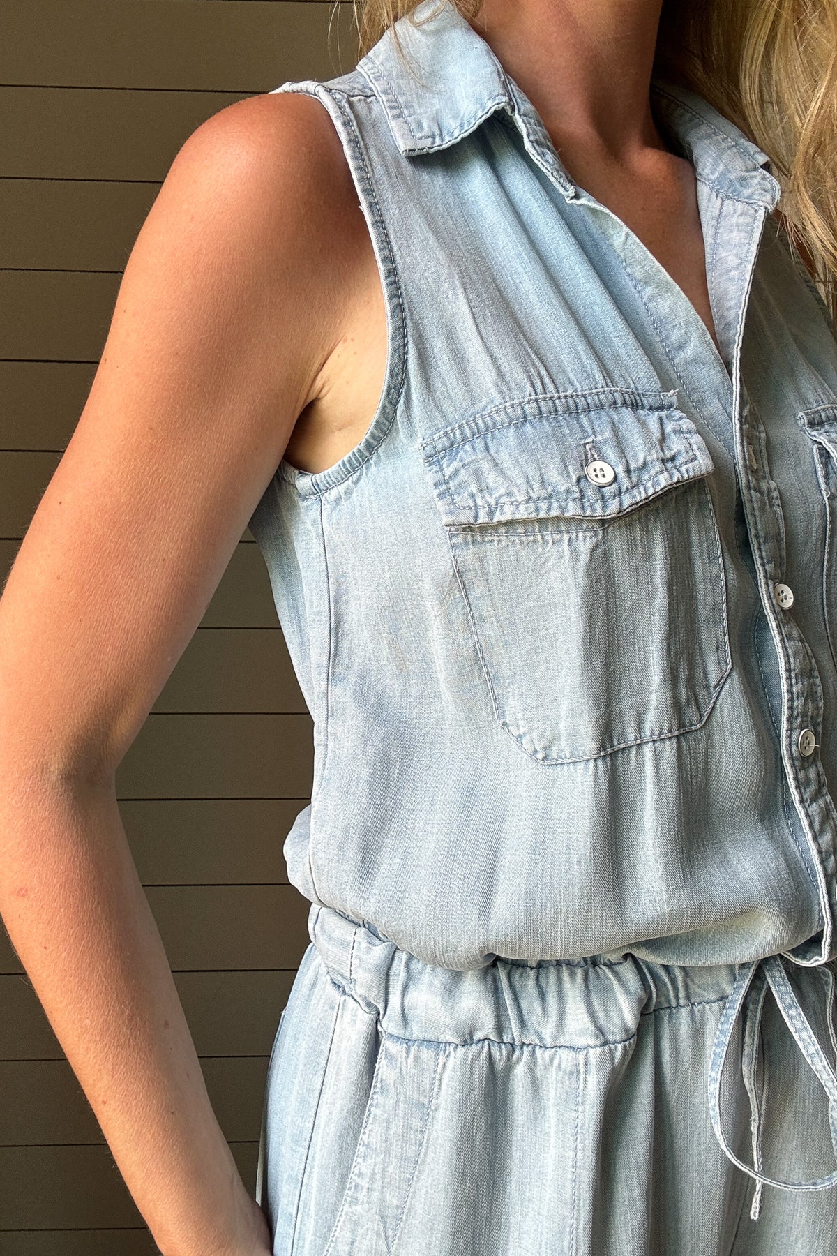 Meet your new go-to: the one-and-done Summer Jumper. Made from buttery soft, breathable Tencel fabric, this lightweight style keeps you cool and comfortable all day. The sleeveless design and button-front detail give it a laid-back vibe, while the drawstring waist adds shape without sacrificing ease. Chest pockets and relaxed-fit legs keep the look casual but pulled together—perfect for weekends, errands, or travel. Pair with sneakers or sandals and you're out the door in minutes. Made with sustainable fabr