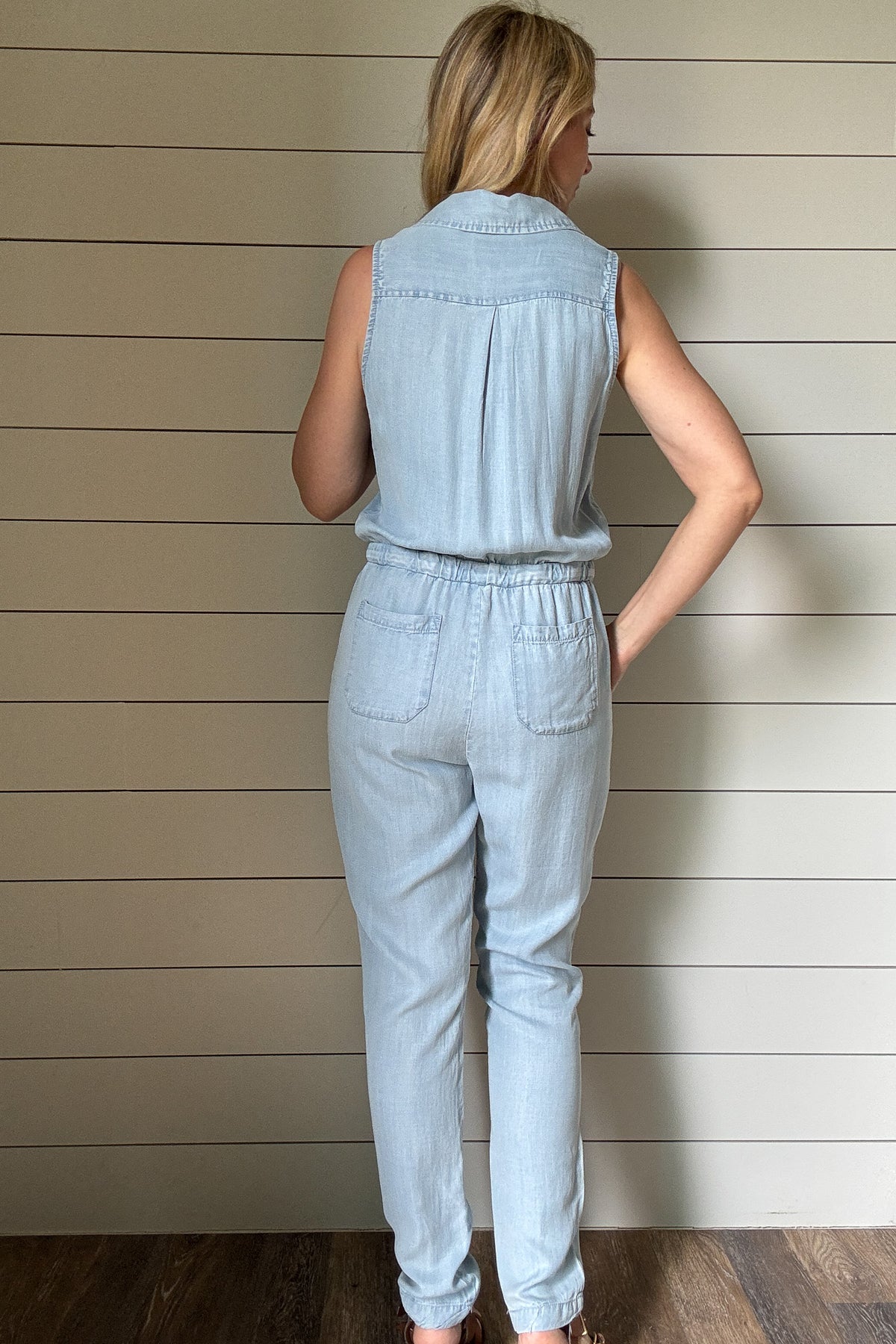 Meet your new go-to: the one-and-done Summer Jumper. Made from buttery soft, breathable Tencel fabric, this lightweight style keeps you cool and comfortable all day. The sleeveless design and button-front detail give it a laid-back vibe, while the drawstring waist adds shape without sacrificing ease. Chest pockets and relaxed-fit legs keep the look casual but pulled together—perfect for weekends, errands, or travel. Pair with sneakers or sandals and you're out the door in minutes. Made with sustainable fabr