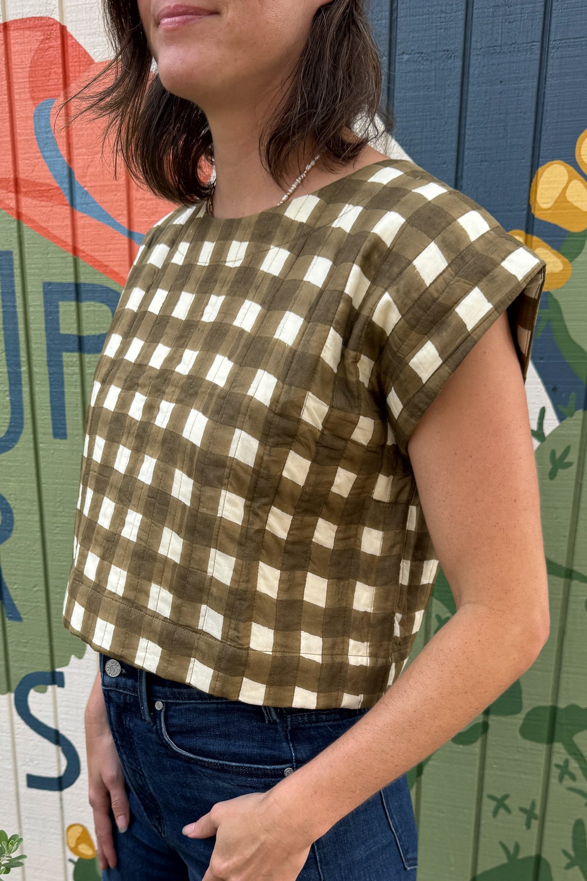 Lightweight quilted cotton gingham top for women featuring a relaxed boxy silhouette and subtle cap sleeves.