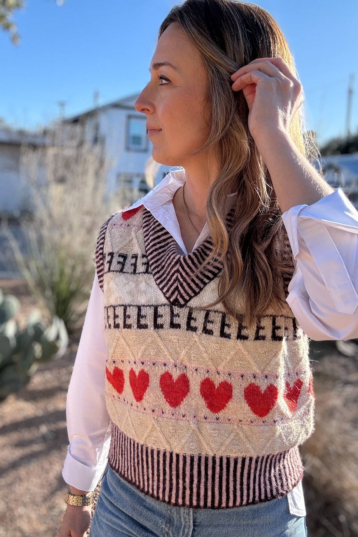 This sweater vest brings a charming, elevated touch to everyday outfits! Designed in France, it features a soft knit with a classic V neckline and a playful heart pattern that feels fun but still easy to wear. The neutral base makes it simple to style over a crisp button down or worn on its own as the seasons shift. It layers beautifully without adding bulk and gives your look a cozy, styled finish for workdays or casual plans. An easy piece to dress up denim or add interest to simple basics!