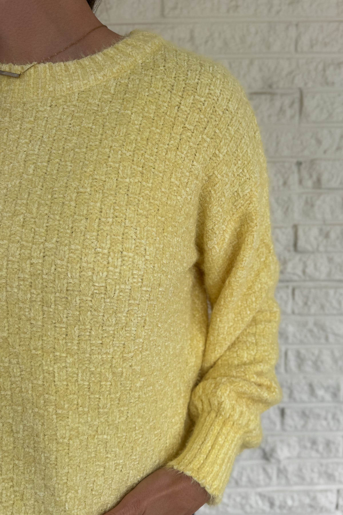 Soft, cheerful, and effortlessly cozy — this braided knit sweater adds a touch of sunshine to cool days. Its subtle checkered texture gives it dimension, while the classic crew neckline and ribbed edges keep it timeless. Easy to pair with denim or skirts for a bright, everyday look.