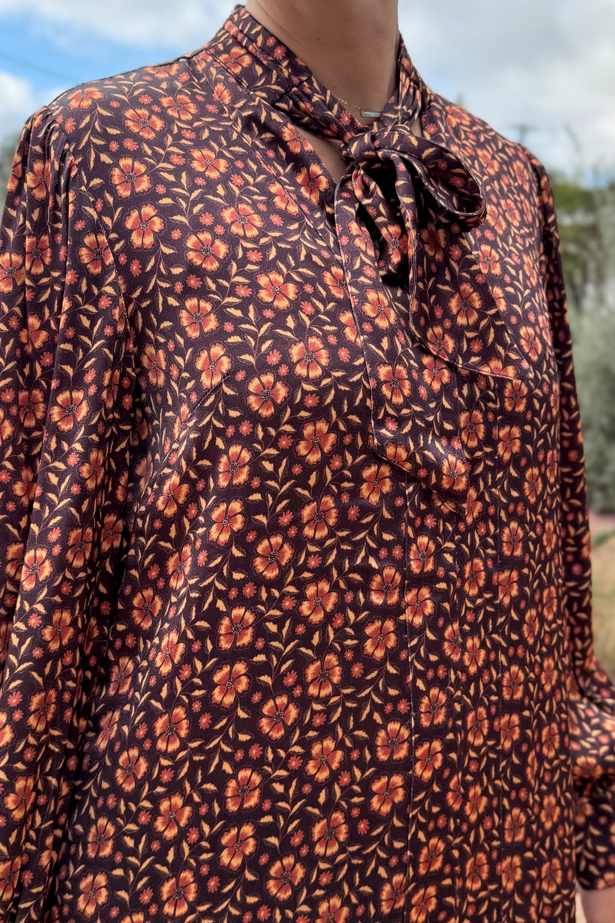 &nbsp;A fresh pop of autumn blooms makes this 34" dress a standout for any occasion. Designed in soft 100% viscose, it flows effortlessly with a relaxed silhouette and features a feminine tie-neck detail for an added touch of charm.
