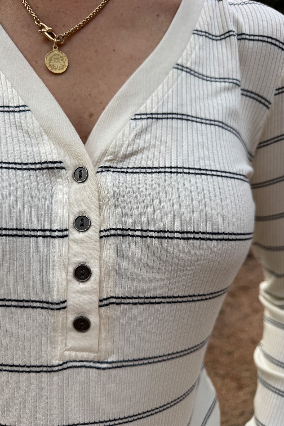 A timeless stripe with an easy, flattering fit,&nbsp; this ribbed henley top is a closet essential. The soft, stretchy knit moves with you while the button neckline adds a touch of laid-back polish. Perfect for layering or pairing with denim for effortless everyday style.