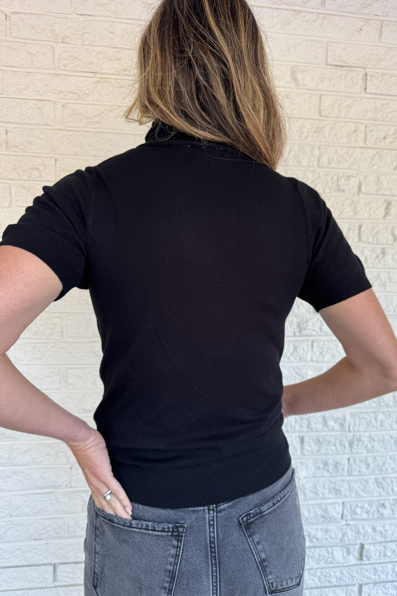 &nbsp;A modern twist on a classic silhouette, this short sleeve turtleneck sweater is sleek and versatile. The soft knit blend drapes comfortably while the fitted design makes it perfect for layering or wearing solo.