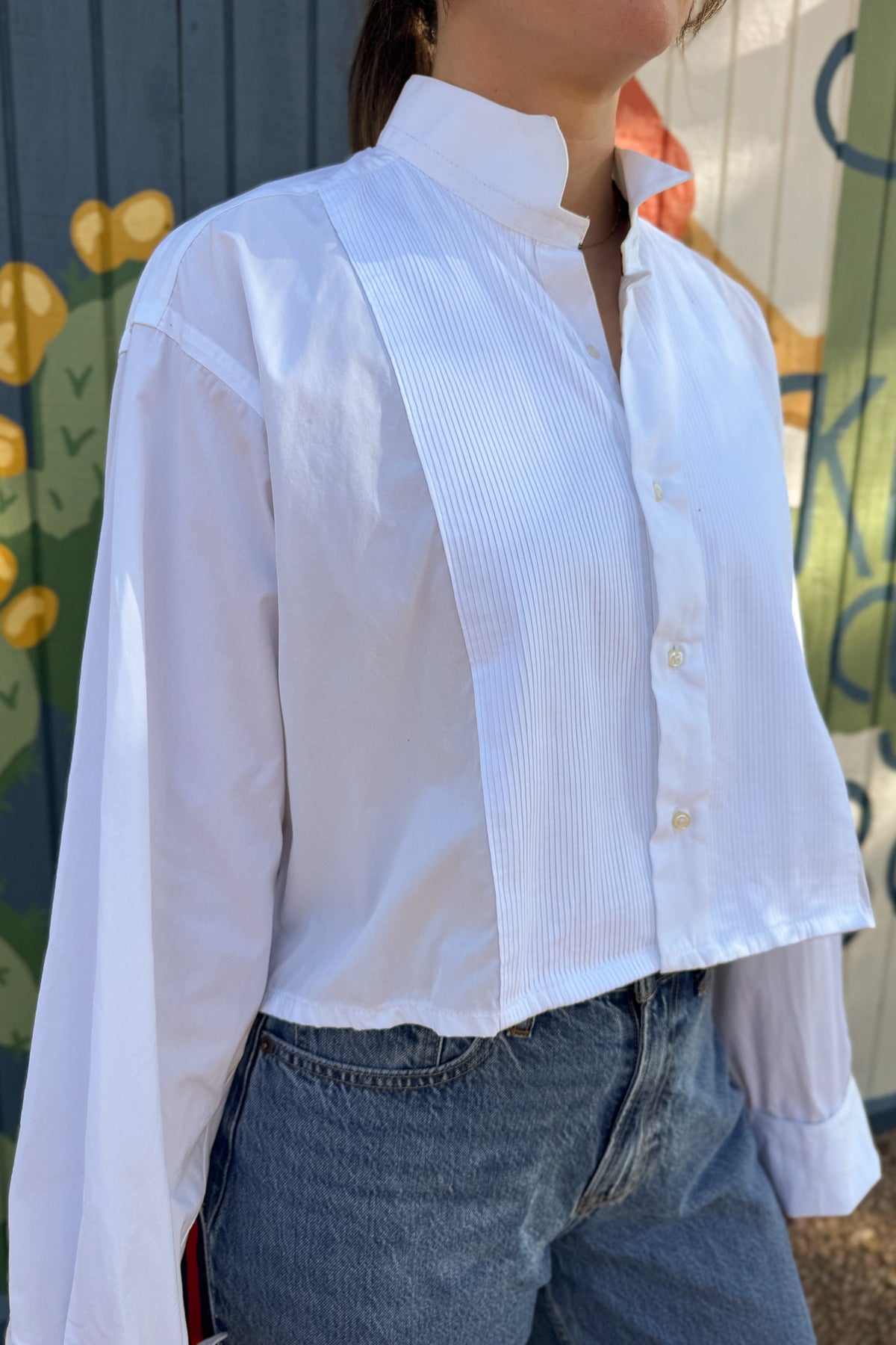 The modern Stormy button-down is designed to move with you for an easy, elevated feel. The cropped front flows into a longer back for a flattering high-low shape that adds interest to a classic style. Finished details give this piece a polished look that works dressed up or casual.