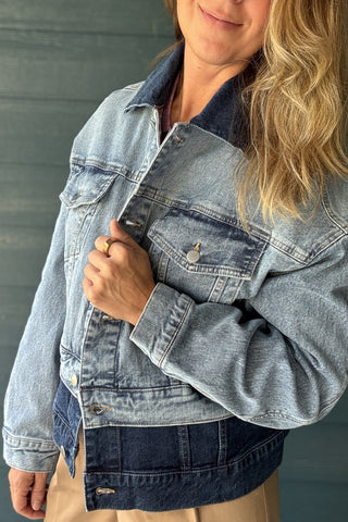 Women’s two-tone denim jacket with light wash body, dark wash collar and contrasting dark denim hem at Cotton & Cashmere boutique in Blanco, Texas.
