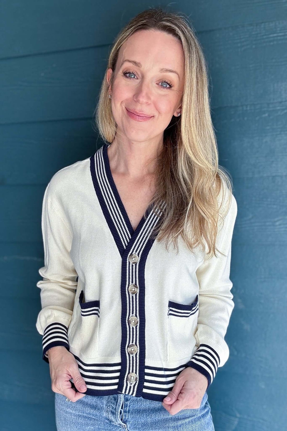 The Madilyn Varsity Cardigan adds a preppy twist to your everyday style. Crafted from 100% GOTS Certified Organic Cotton, it features varsity-inspired stripes and patch pockets with contrast stitching. The boxy, slightly cropped silhouette adds a contemporary edge, making it perfect for layering over your favorite tops. But what truly sets this cardigan apart is its sustainability. Made with 100% GOTS Certified Organic Cotton, it not only reduces environmental impact but also supports fair labor practices t