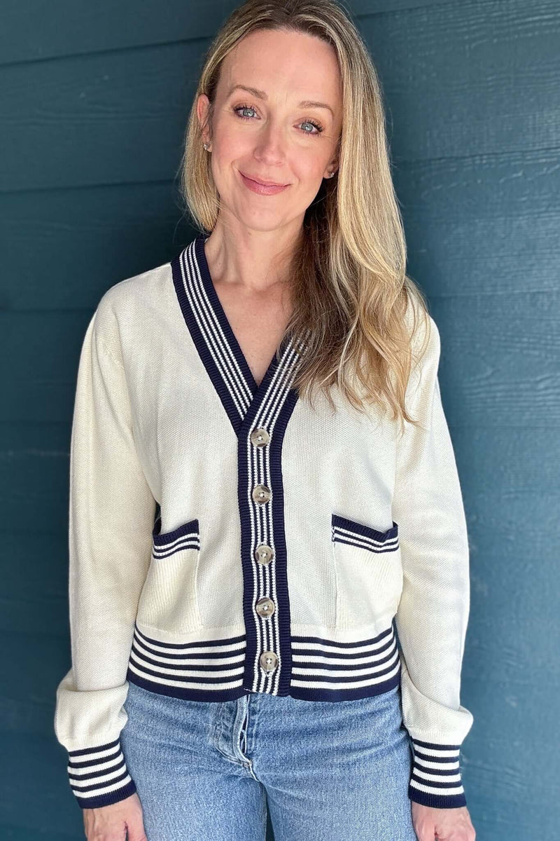 The Madilyn Varsity Cardigan adds a preppy twist to your everyday style. Crafted from 100% GOTS Certified Organic Cotton, it features varsity-inspired stripes and patch pockets with contrast stitching. The boxy, slightly cropped silhouette adds a contemporary edge, making it perfect for layering over your favorite tops. But what truly sets this cardigan apart is its sustainability. Made with 100% GOTS Certified Organic Cotton, it not only reduces environmental impact but also supports fair labor practices t