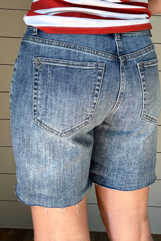 Meet your new favorite denim short! With a 6.5” raw hem that can be rolled for a customized length, these shorts offer effortless versatility. Designed with a straight cut that fits comfortably in the thigh—no clinging here—while gently tapering at the waist for a flattering fit. Perfect for the mom who wants a modern, stylish short without the “mom short” feel. Dress them up or down for an easy, go-to summer look!