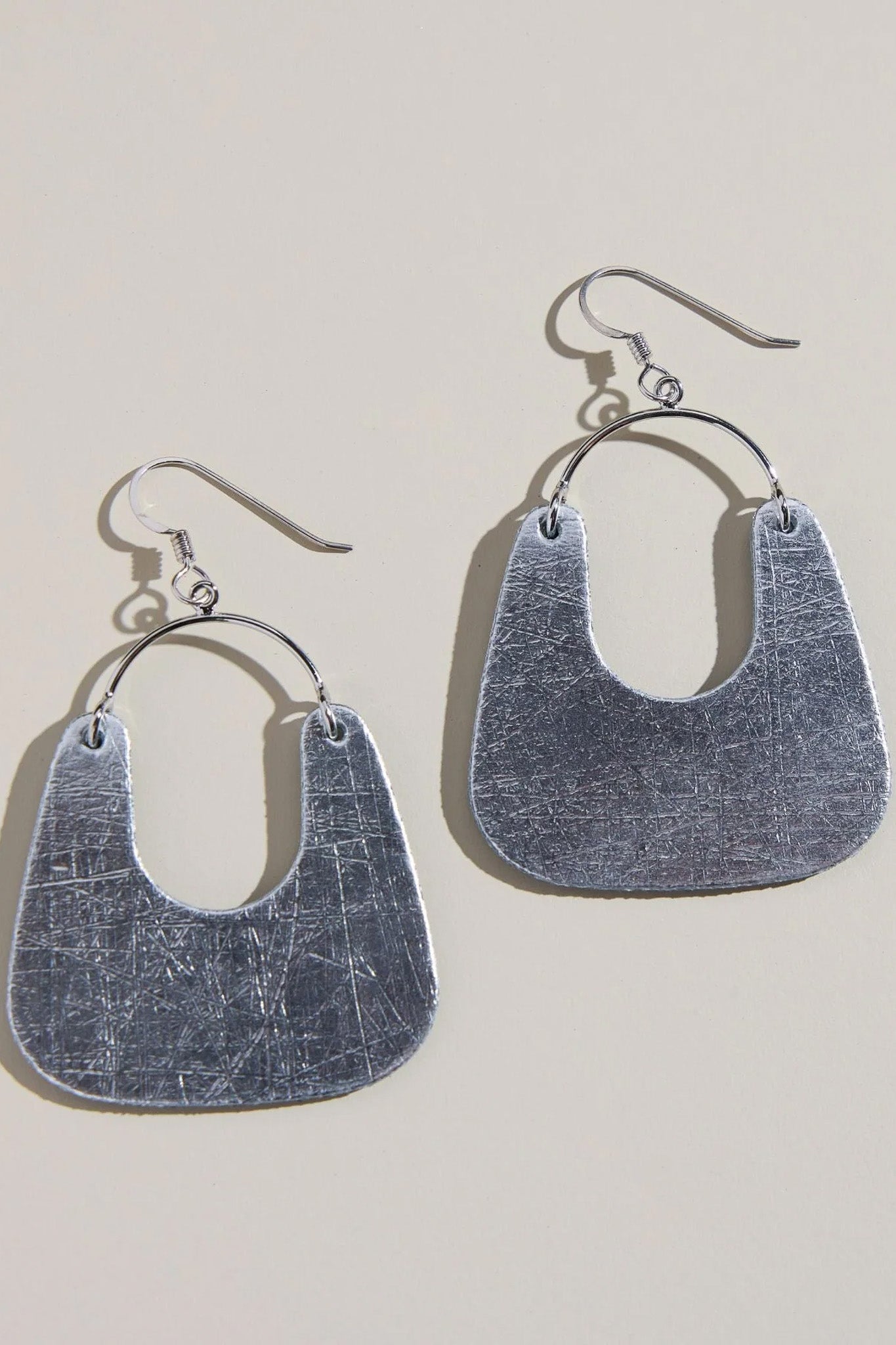 silver statement earrings, leather statement earrings, vintage silver earrings, lightweight earrings, modern silhouette earrings, sterling silver ear wire earrings, nickel free earrings, boutique jewelry, women’s fashion jewelry, statement earrings for women, effortless style accessories, silver drop earrings, chic everyday earrings, unique leather earrings, Cotton & Cashmere boutique, Blanco Texas boutique, women’s jewelry online, modern women’s accessories