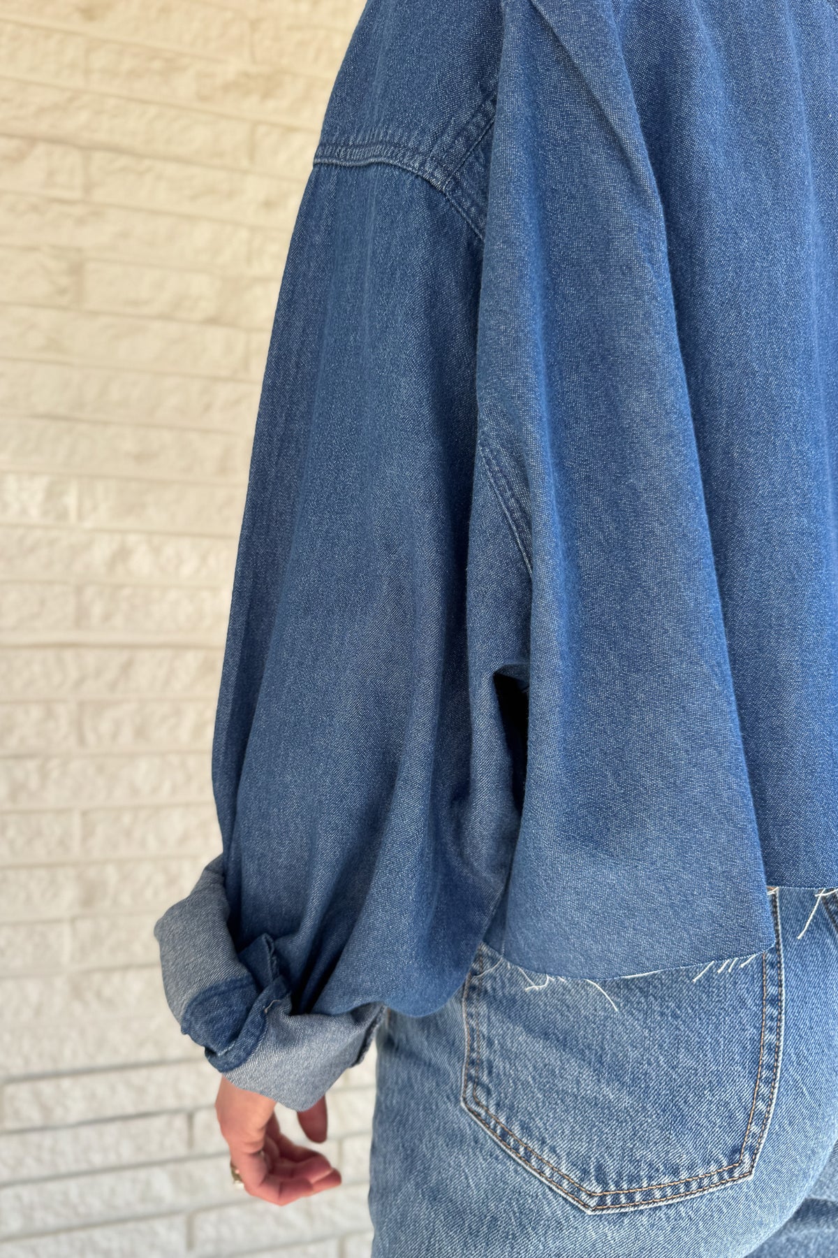An upcycled men’s shirt reworked into a cropped, raw hem, easy silhouette that feels fresh and relaxed. Soft, classic, and one-of-a-kind. Designed to be a one size fits most, wear it buttoned up and it fits like medium or large.