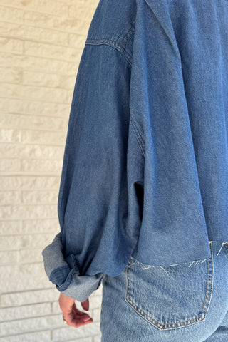 An upcycled men’s shirt reworked into a cropped, raw hem, easy silhouette that feels fresh and relaxed. Soft, classic, and one-of-a-kind. Designed to be a one size fits most, wear it buttoned up and it fits like medium or large Women's fashion boutique Blanco Texas Johnson City Texas
