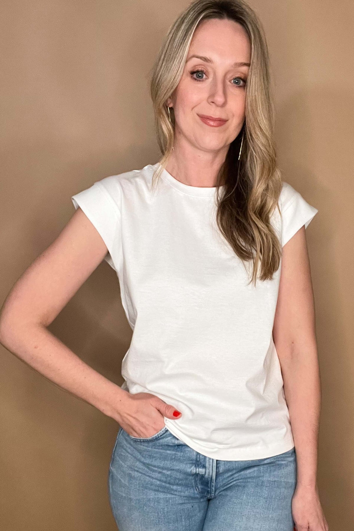 Elevate your wardrobe with our White Shoulder Detail Tee! This closet staple is made from 100% cotton, offering both comfort and style. The shoulder detailing adds a unique touch to this classic white tee. Perfect for layering or pairing with denim cut offs for a timeless warm weather look.