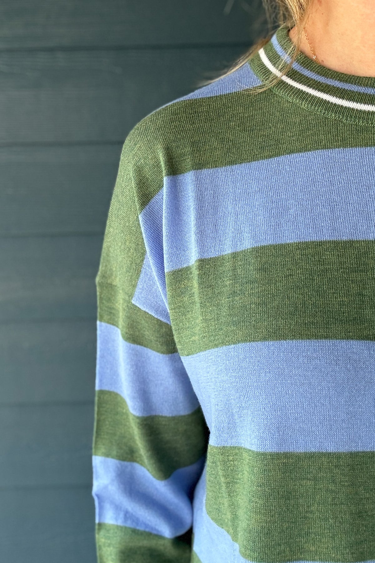 Women’s long sleeve striped sweater in olive green and soft blue with a relaxed silhouette, dropped shoulders and lightweight knit texture.
