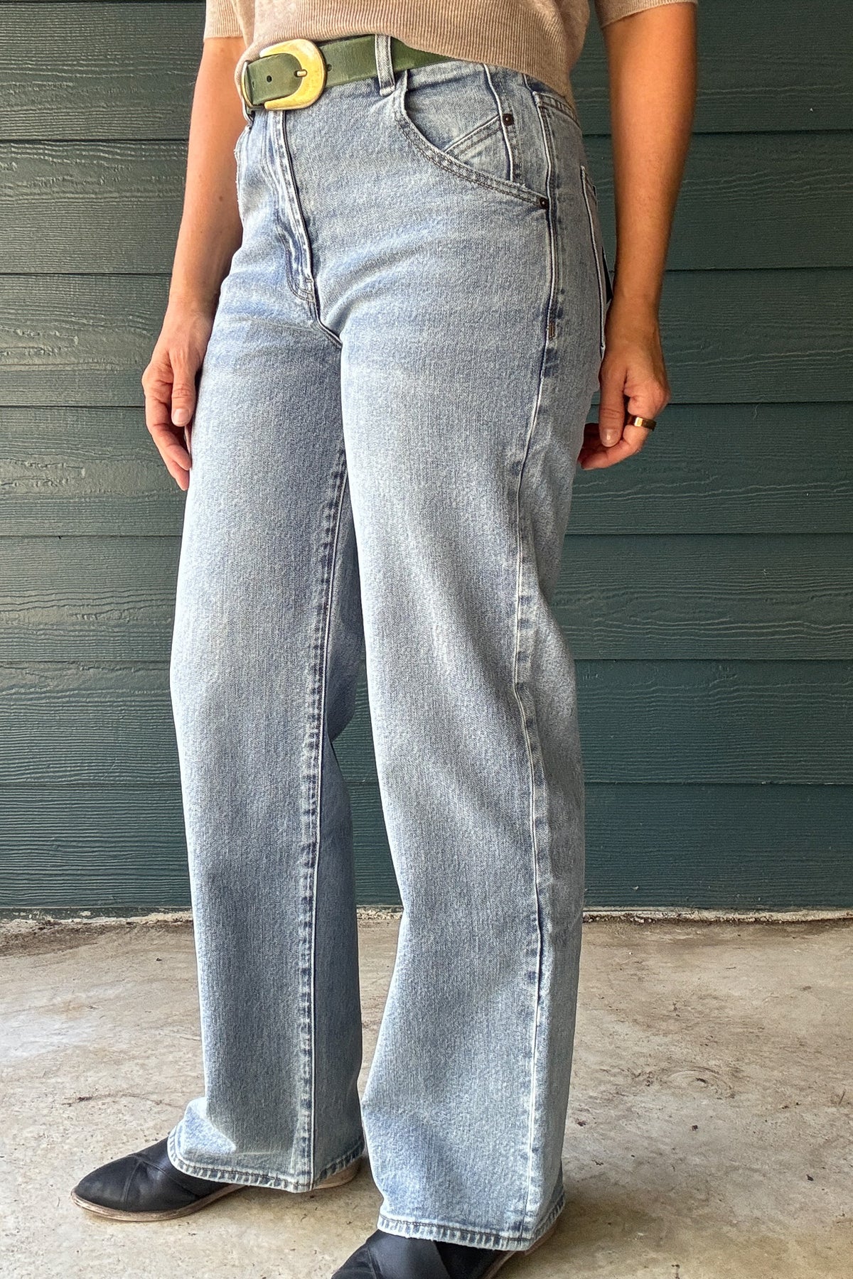 Women’s light wash high-rise jeans with a wide-leg fit, curved front pocket detail and full-length hem.